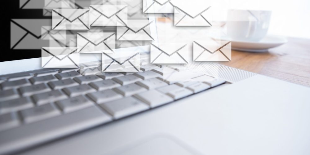 Digital composite of New mails appearing beside laptop